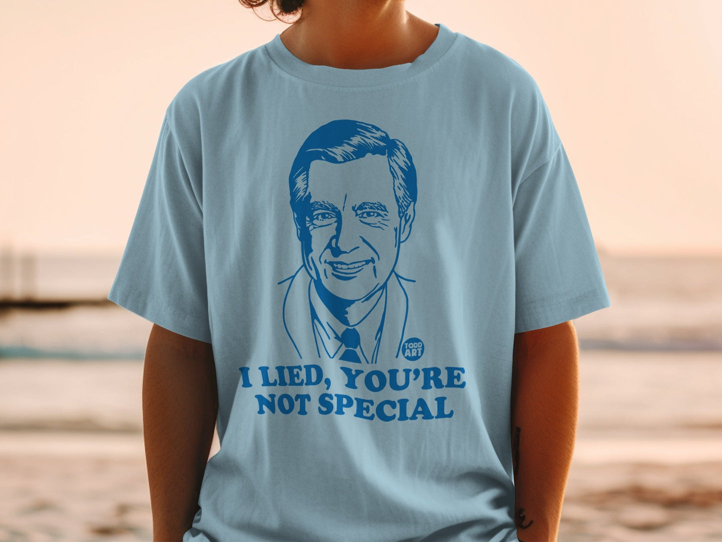 Light blue t-shirt with a blue graphic of Fred Rogers and text "I LIED, YOU'RE NOT SPECIAL".