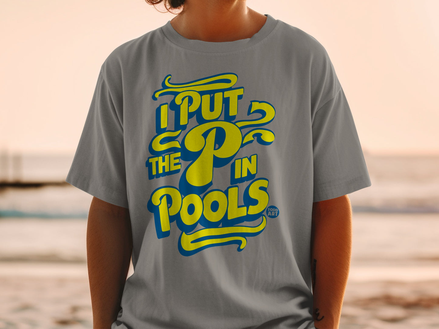 Gray t-shirt with yellow text "I PUT THE P IN POOLS".