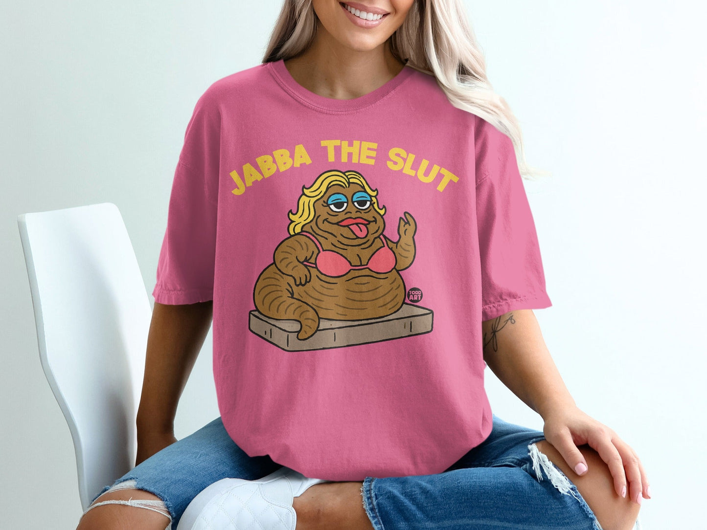 Pink t-shirt with cartoon Jabba the Hutt in a bikini, text "JABBA THE SLUT".