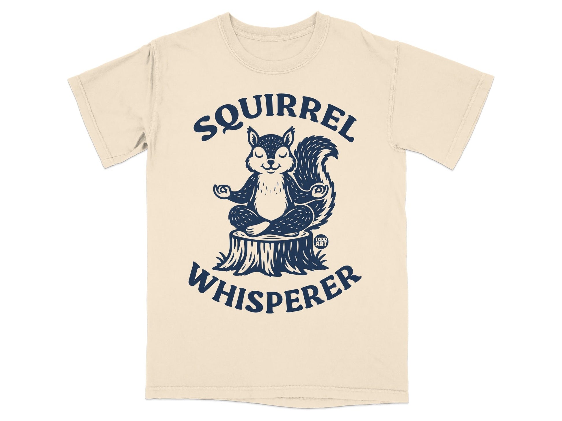 T-shirt graphic of a squirrel meditating on a tree stump with "Squirrel Whisperer" text.