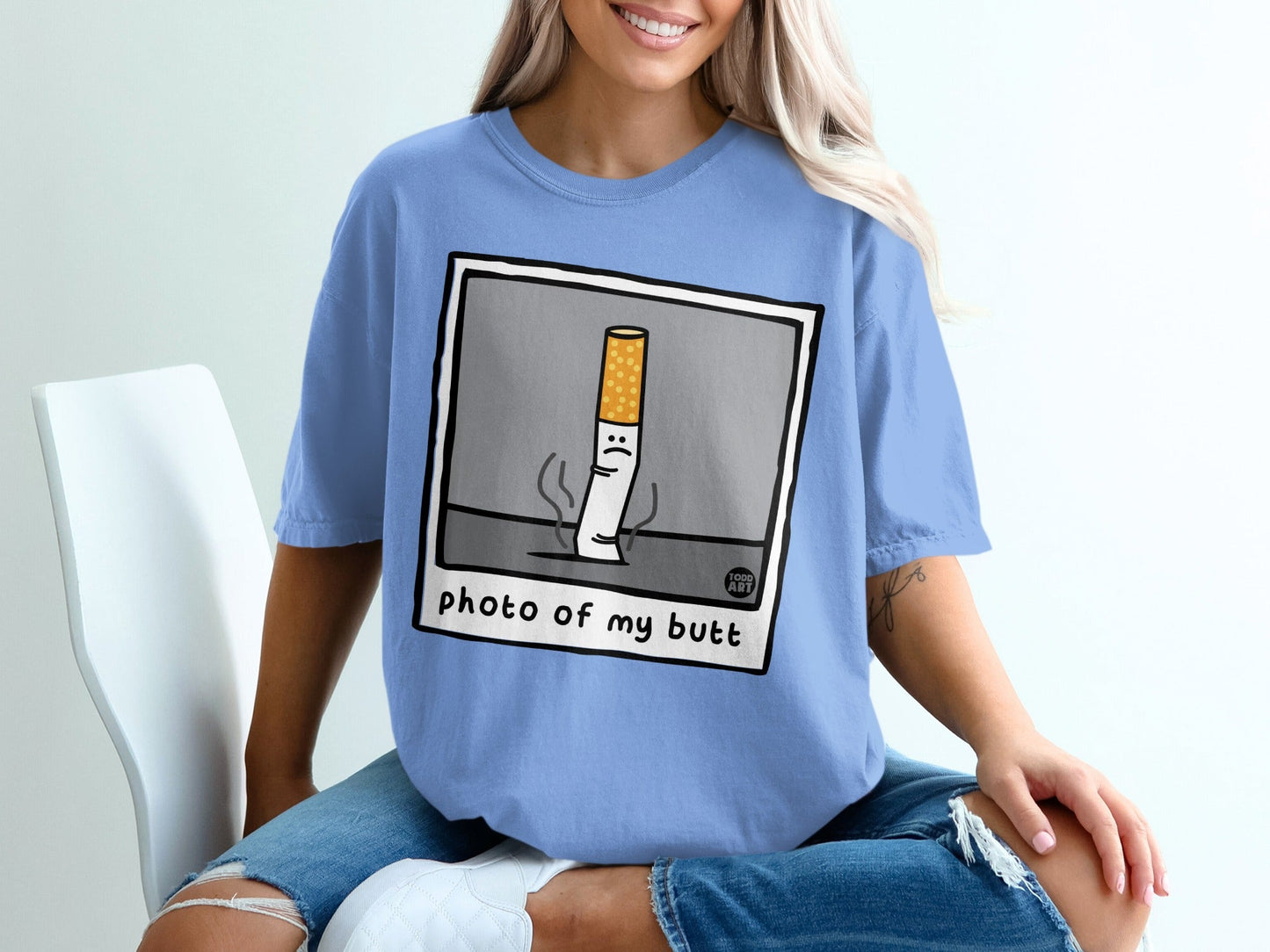 Blue t-shirt with a cartoon cigarette graphic and text "photo of my butt".
