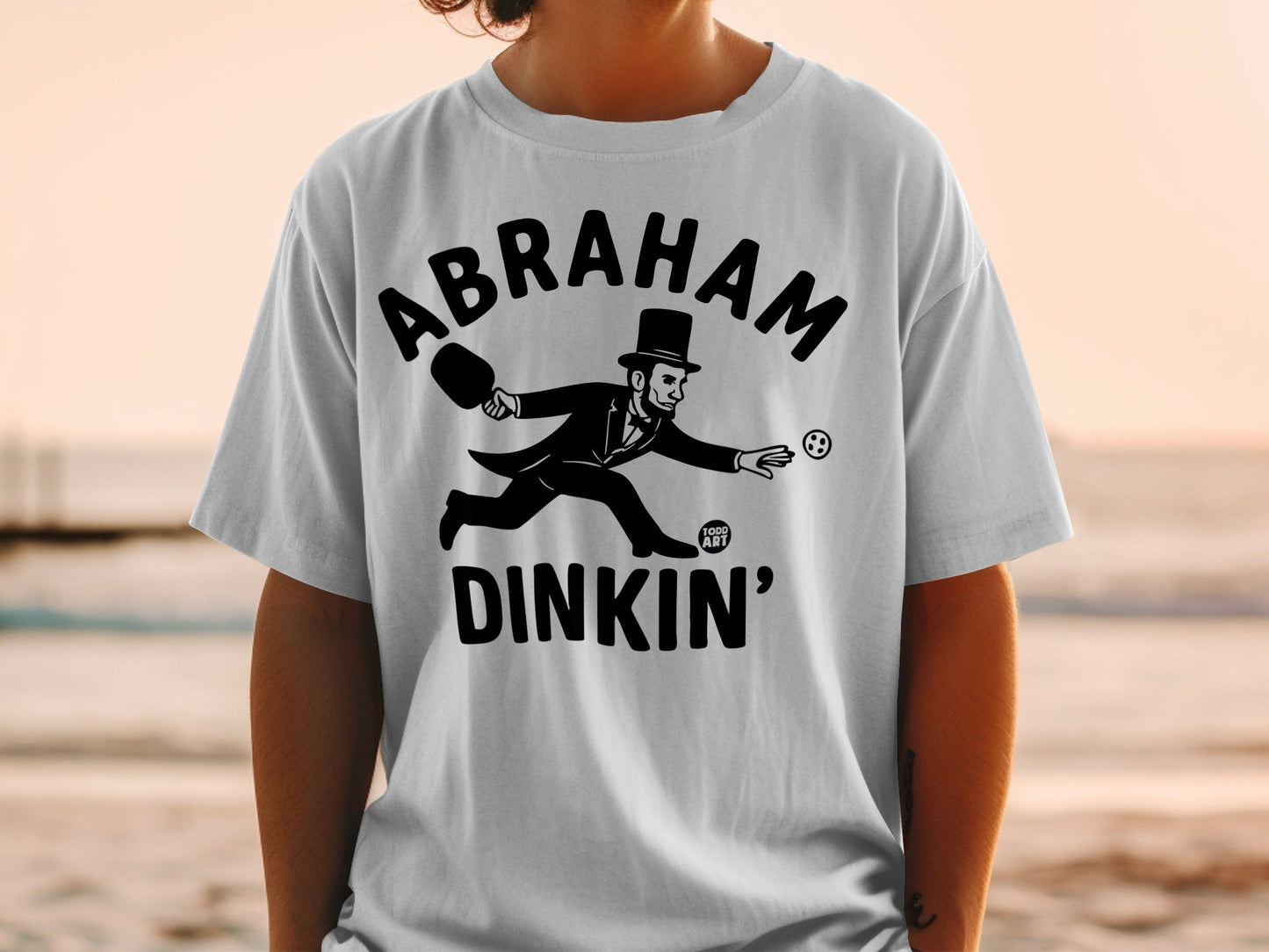 Abraham Lincoln wearing a top hat playing a game on a t-shirt.