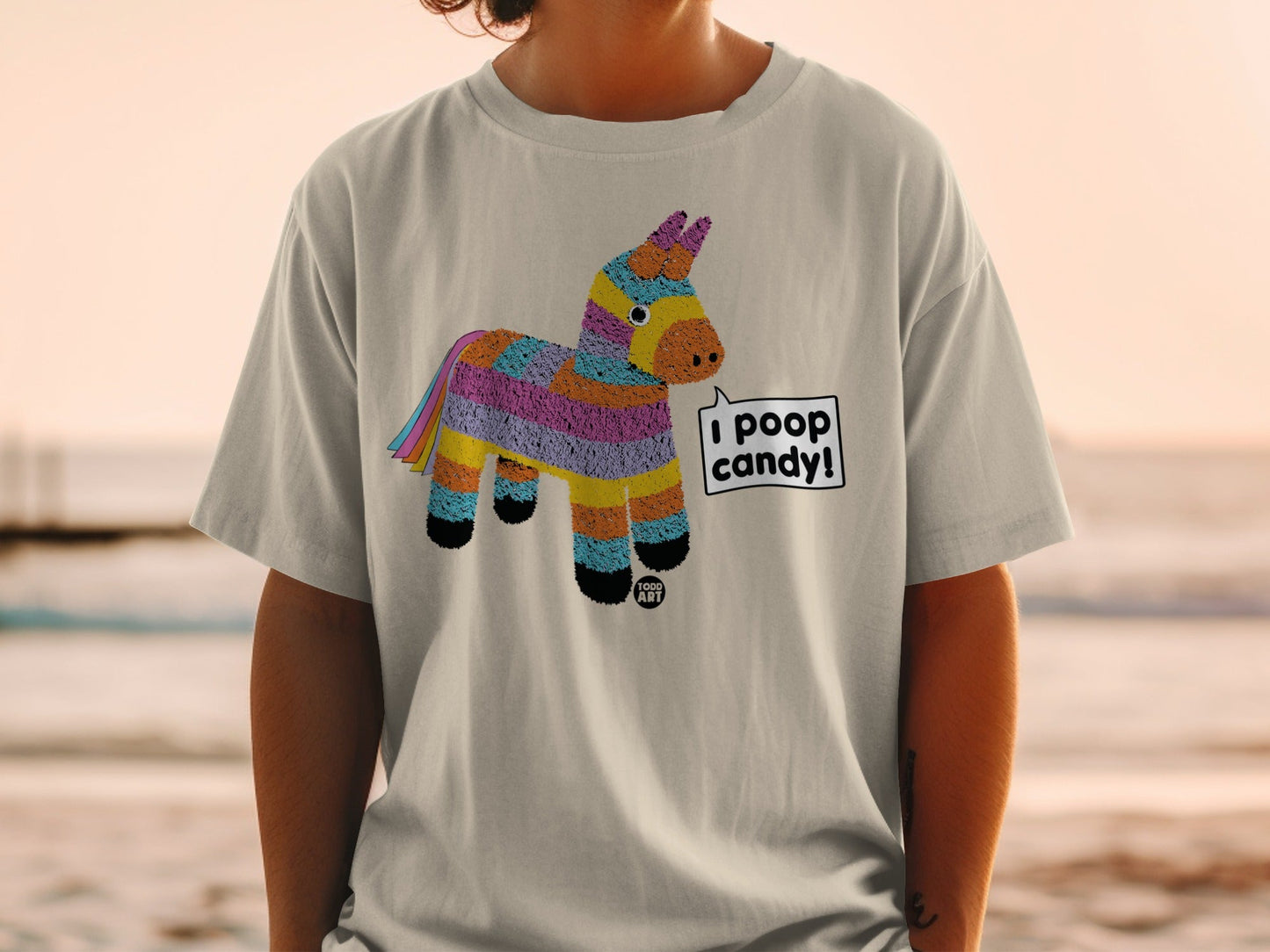 T-shirt with a colorful pinata graphic and text bubble saying "I poop candy".