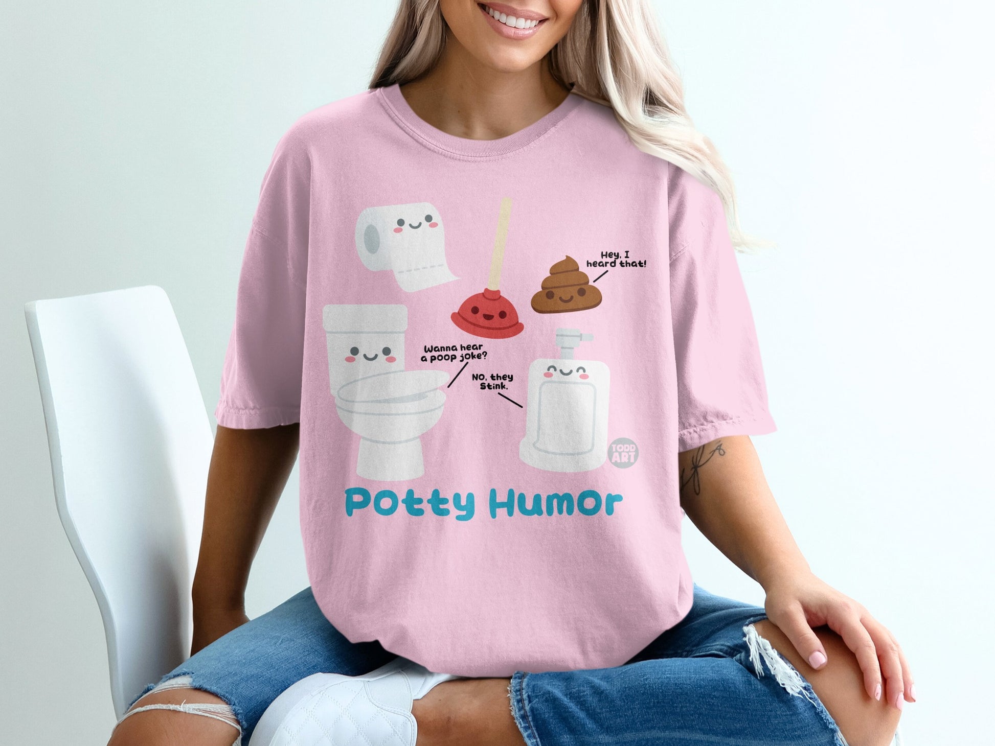 Pink t-shirt with cartoon toilet, toilet paper, soap, and poop characters and "Potty Humor" text.
