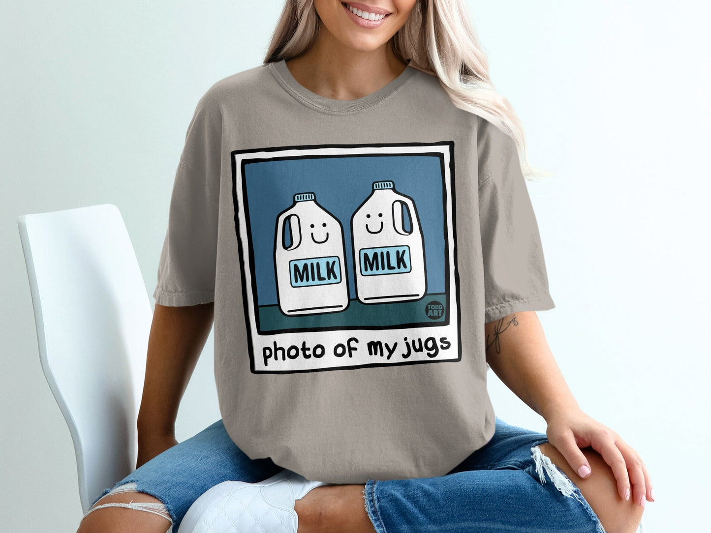 T-shirt with cartoon milk jugs.