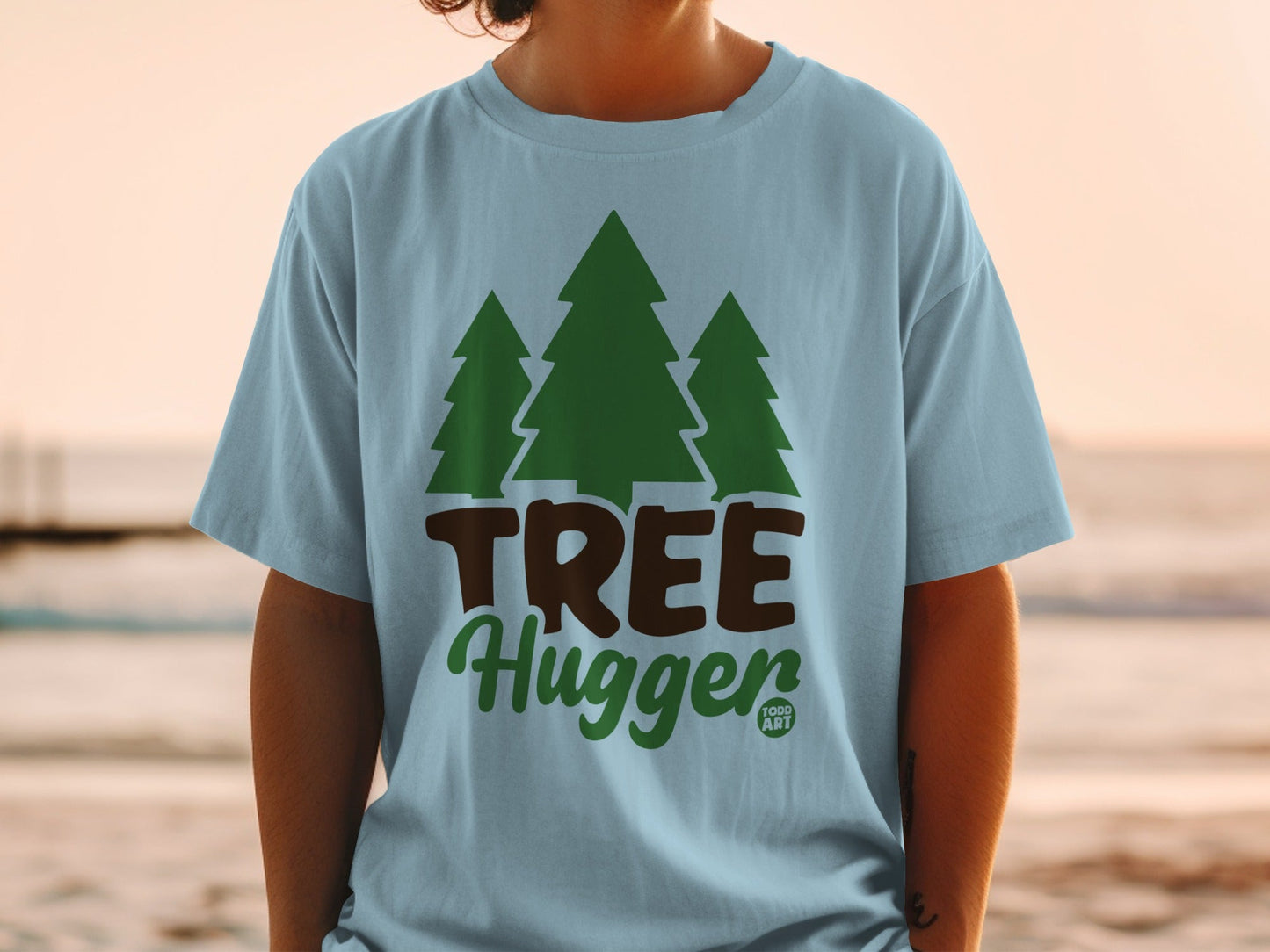 Light blue t-shirt with green trees and "TREE Hugger Food Art" text.