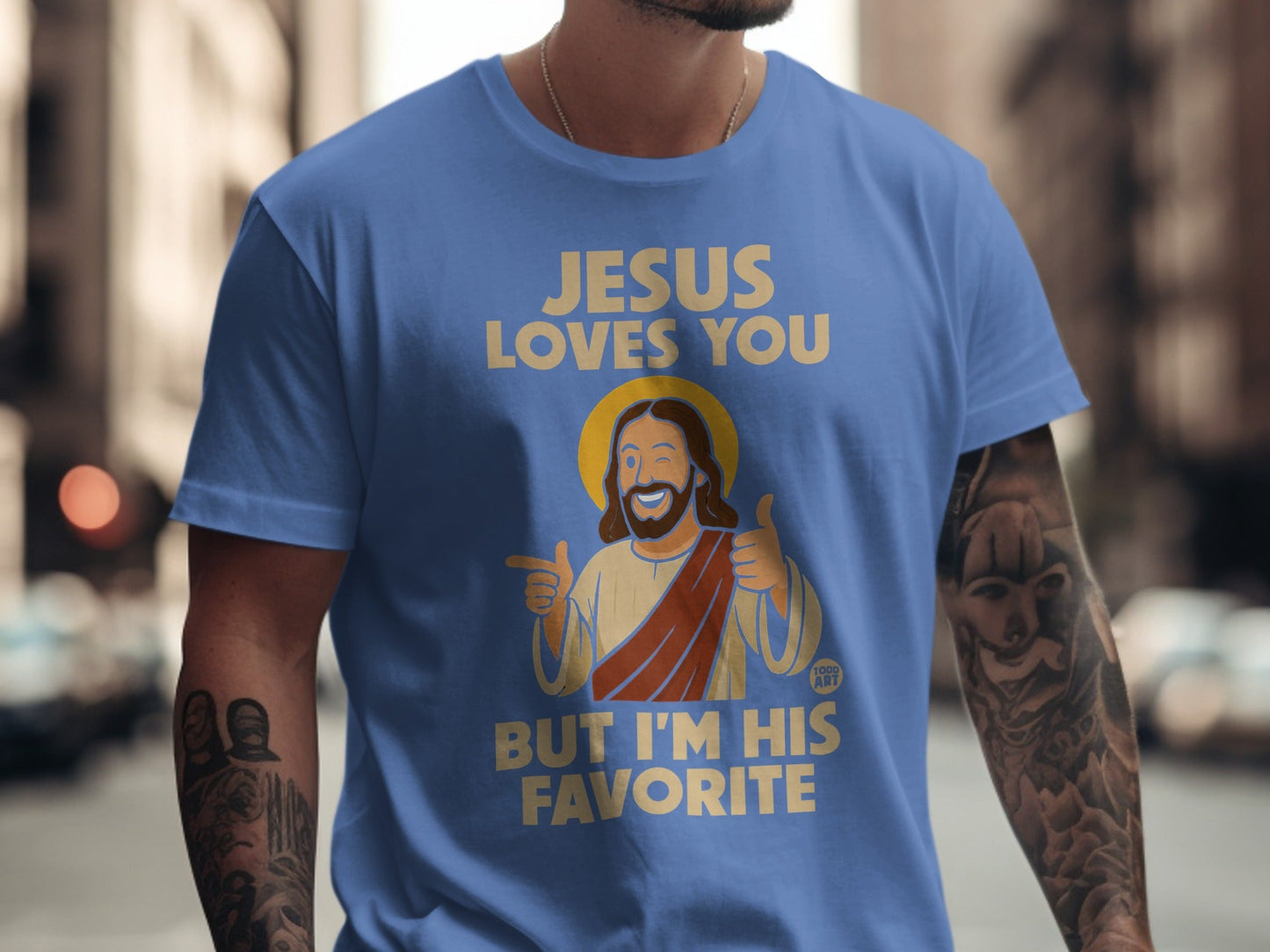 Blue t-shirt with "Jesus loves you but I'm his favorite" and cartoon Jesus.