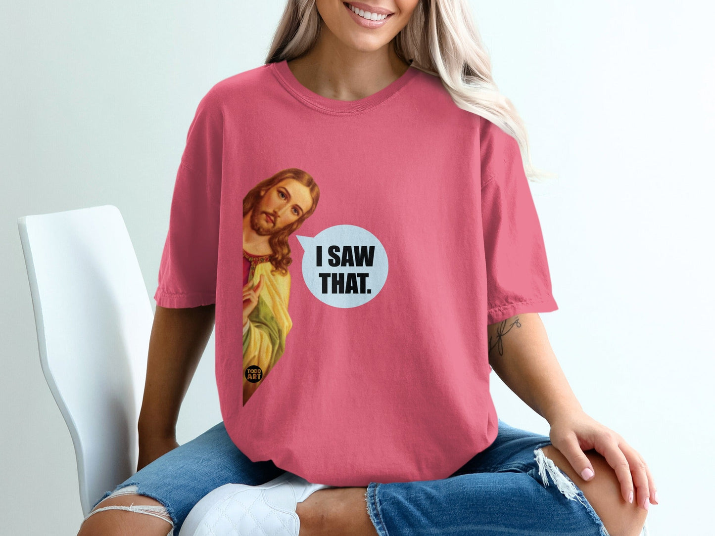 Pink t-shirt with "I SAW THAT." text and Jesus graphic.