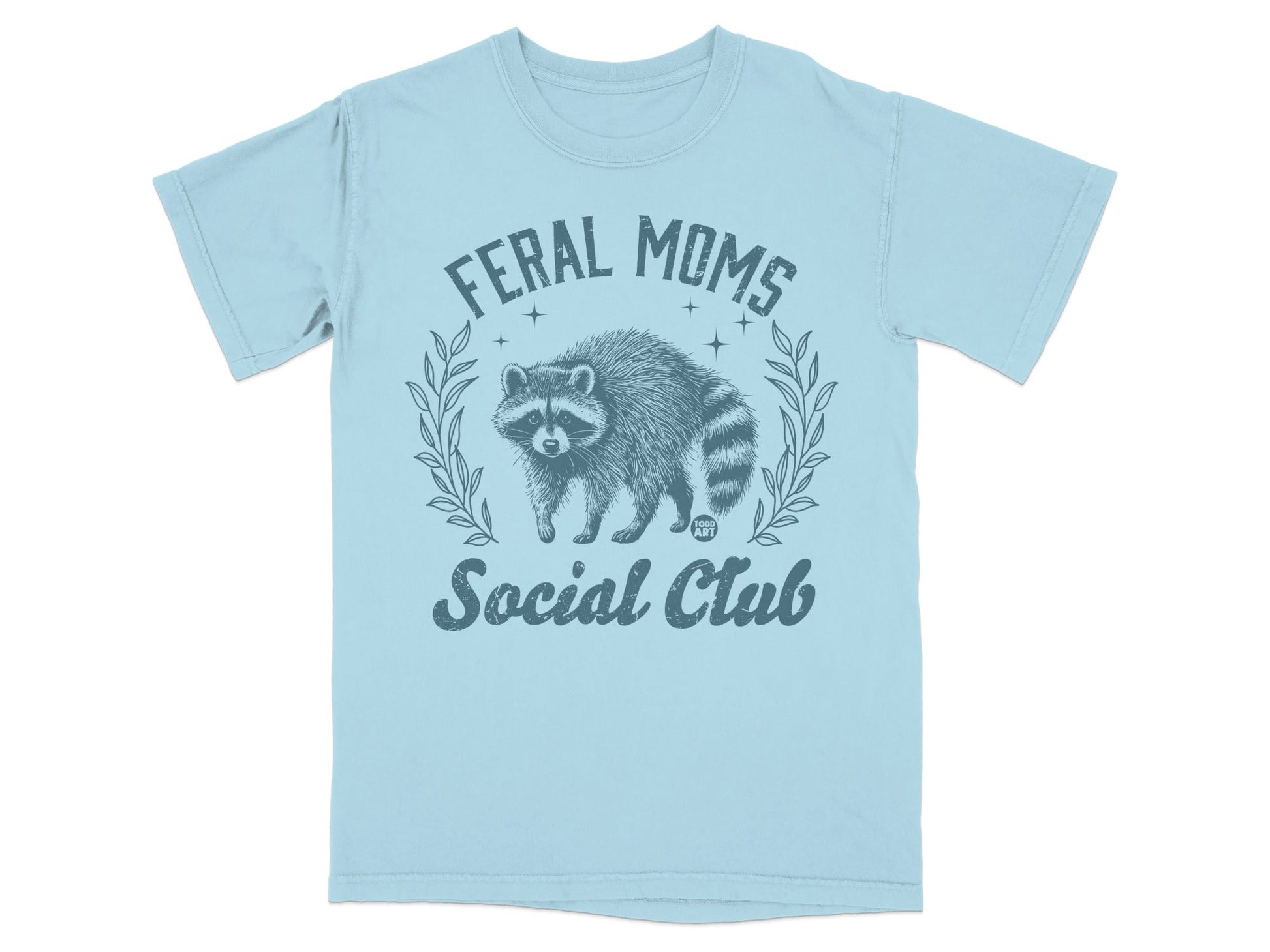 Light blue t-shirt with a distressed graphic of a raccoon and "Feral Moms Social Club" text.