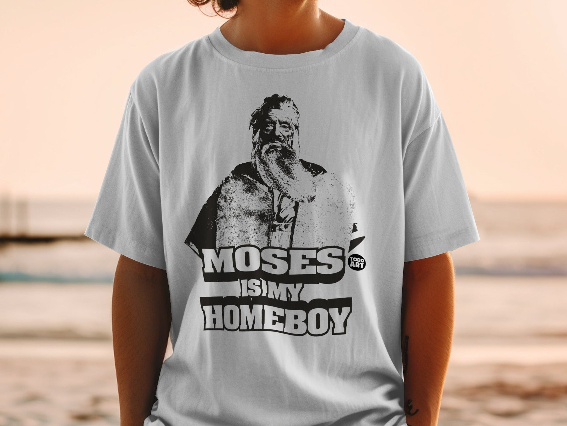 T-shirt with a black and white illustration of Moses, "MOSES IS MY HOMEBOY" text.