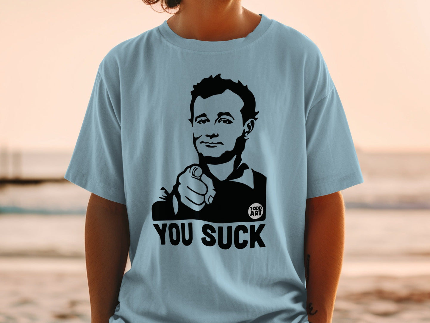 Light blue t-shirt with black graphic of Bill Murray pointing, reading "YOU SUCK".