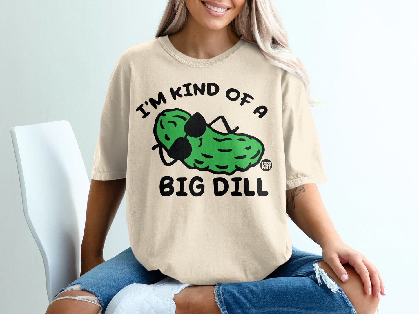 Cream t-shirt with cartoon pickle wearing sunglasses, text "I'm kind of a big dill".
