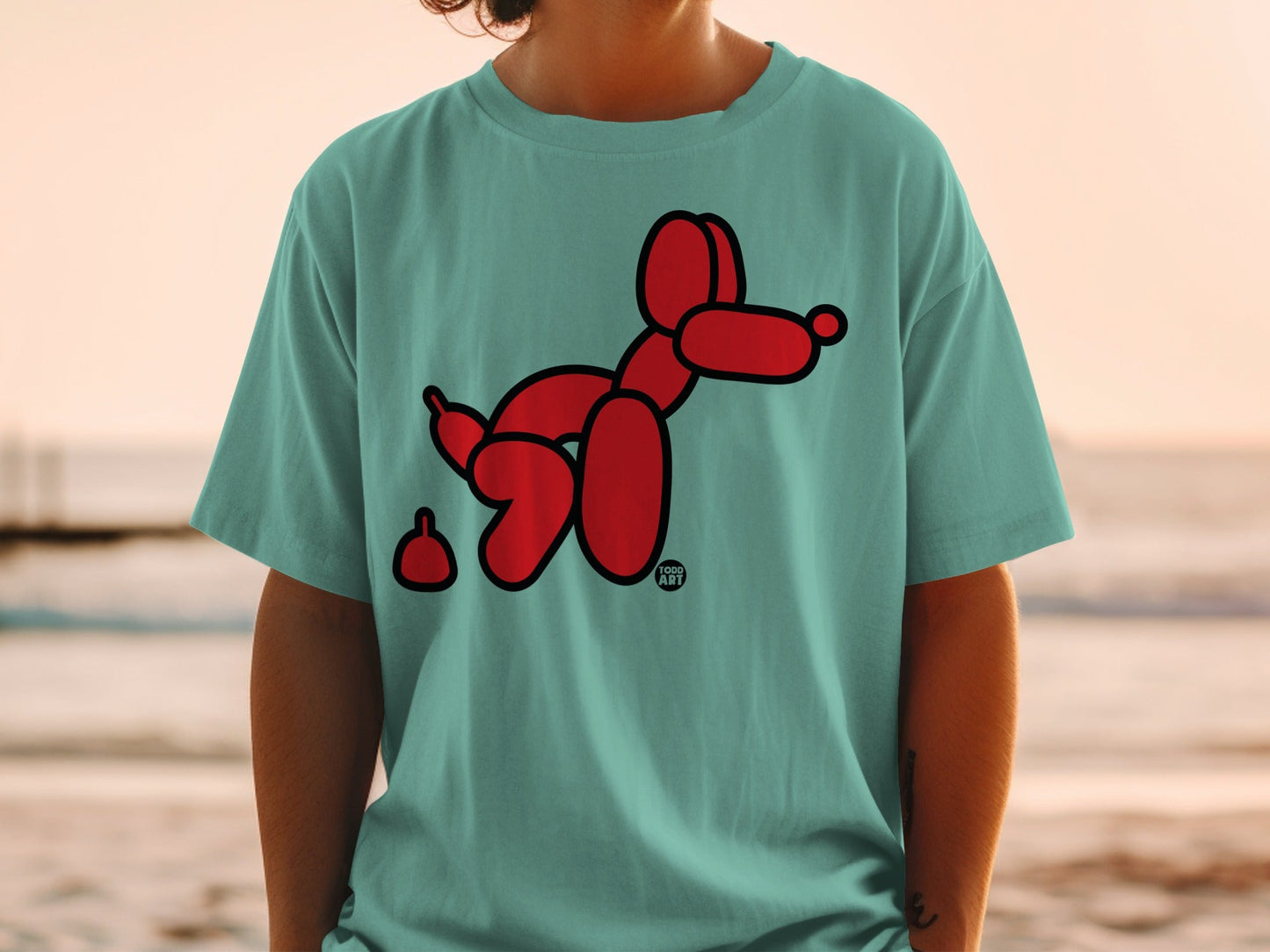 Teal t-shirt with a red balloon dog and a small pile of poop.