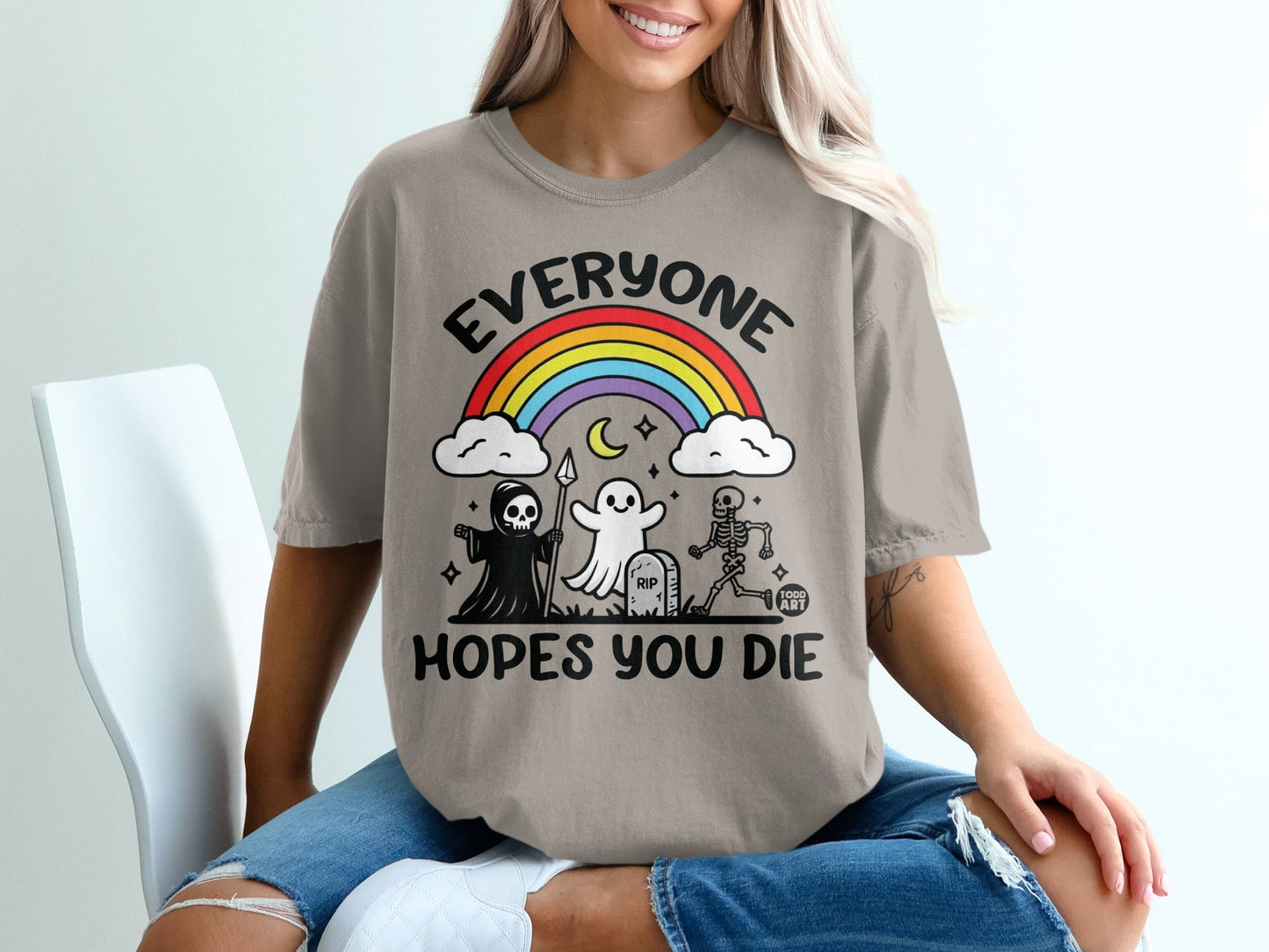 T-shirt with skeleton, ghost, and reaper graphic and rainbow.
