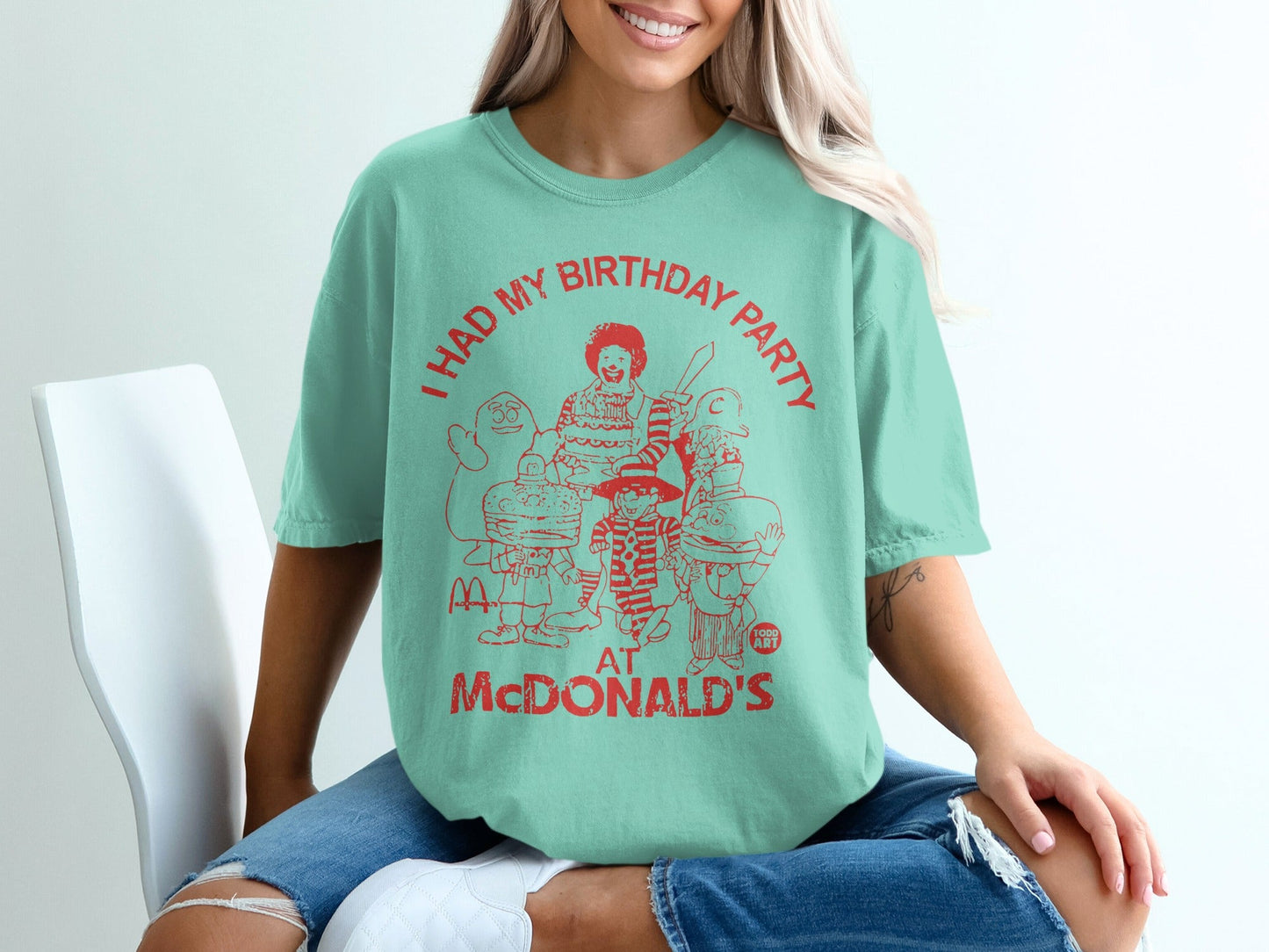 Teal t-shirt with red graphic of McDonaldland characters and "I HAD MY BIRTHDAY PARTY AT MCDONALD'S" text.