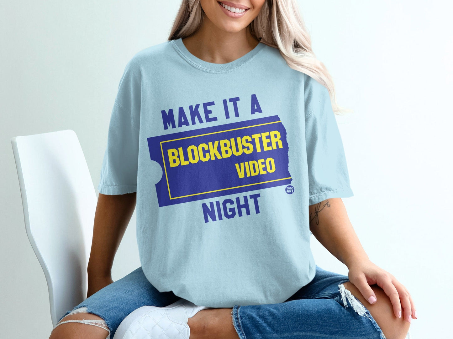 Light blue t-shirt with "MAKE IT A BLOCKBUSTER VIDEO NIGHT" in yellow and blue.
