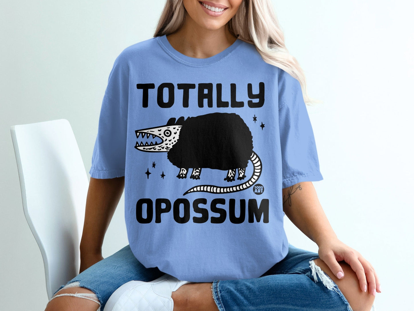 Light blue t-shirt with "TOTALLY OPOSSUM" and cartoon opossum graphic.