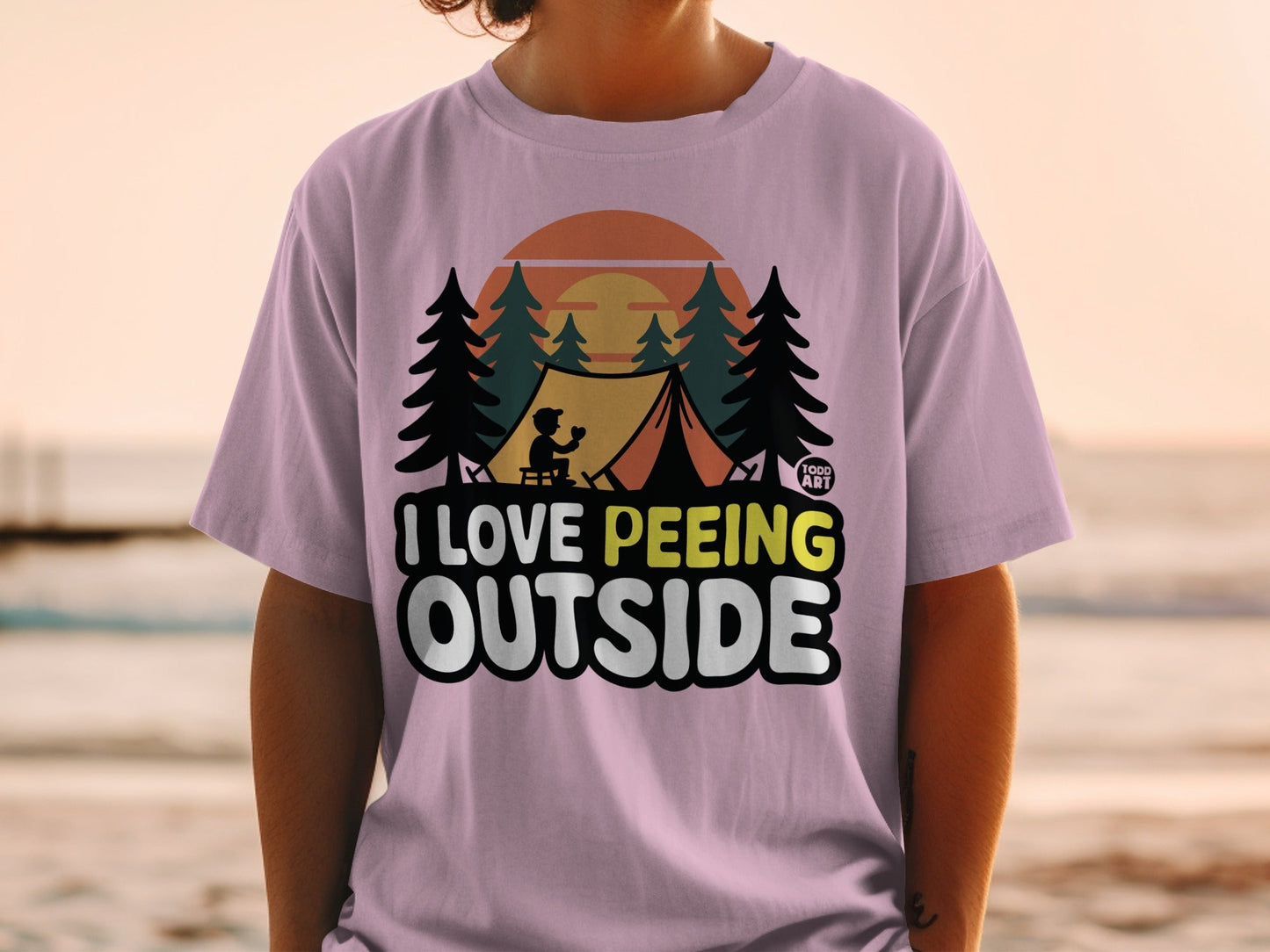 Pink t-shirt with "I Love Peeing Outside" text and camping graphic.