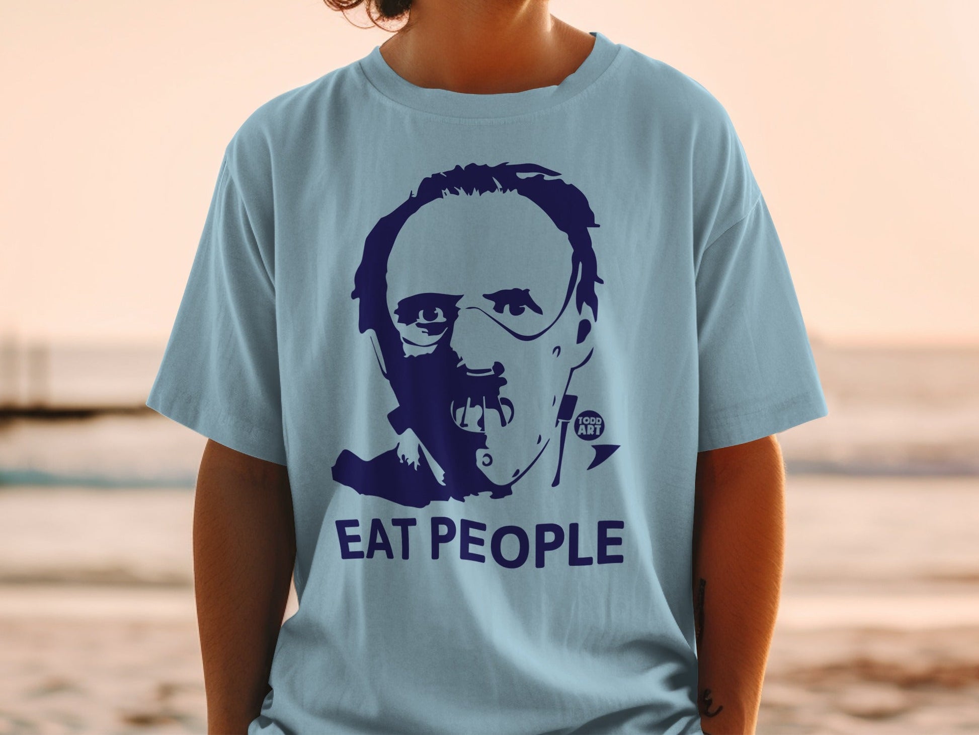 Light blue t-shirt with dark blue graphic of a face and "EAT PEOPLE" text.