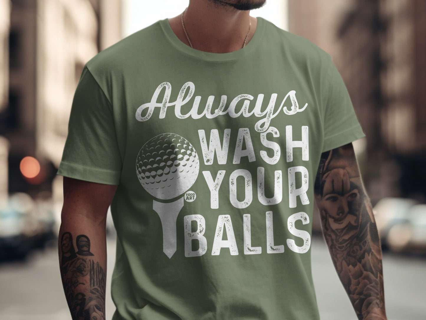 Green t-shirt with white text "Always Wash Your Balls" and golf ball graphic.