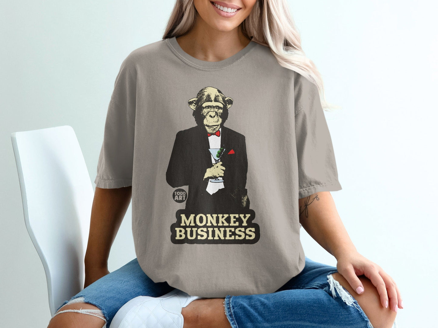 Monkey in a tuxedo holding a martini, "MONKEY BUSINESS" text.