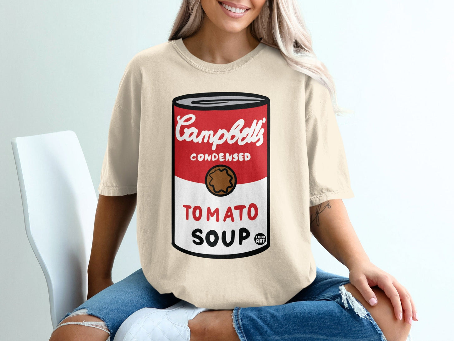 Beige t-shirt with Campbell's Condensed Tomato Soup can graphic.