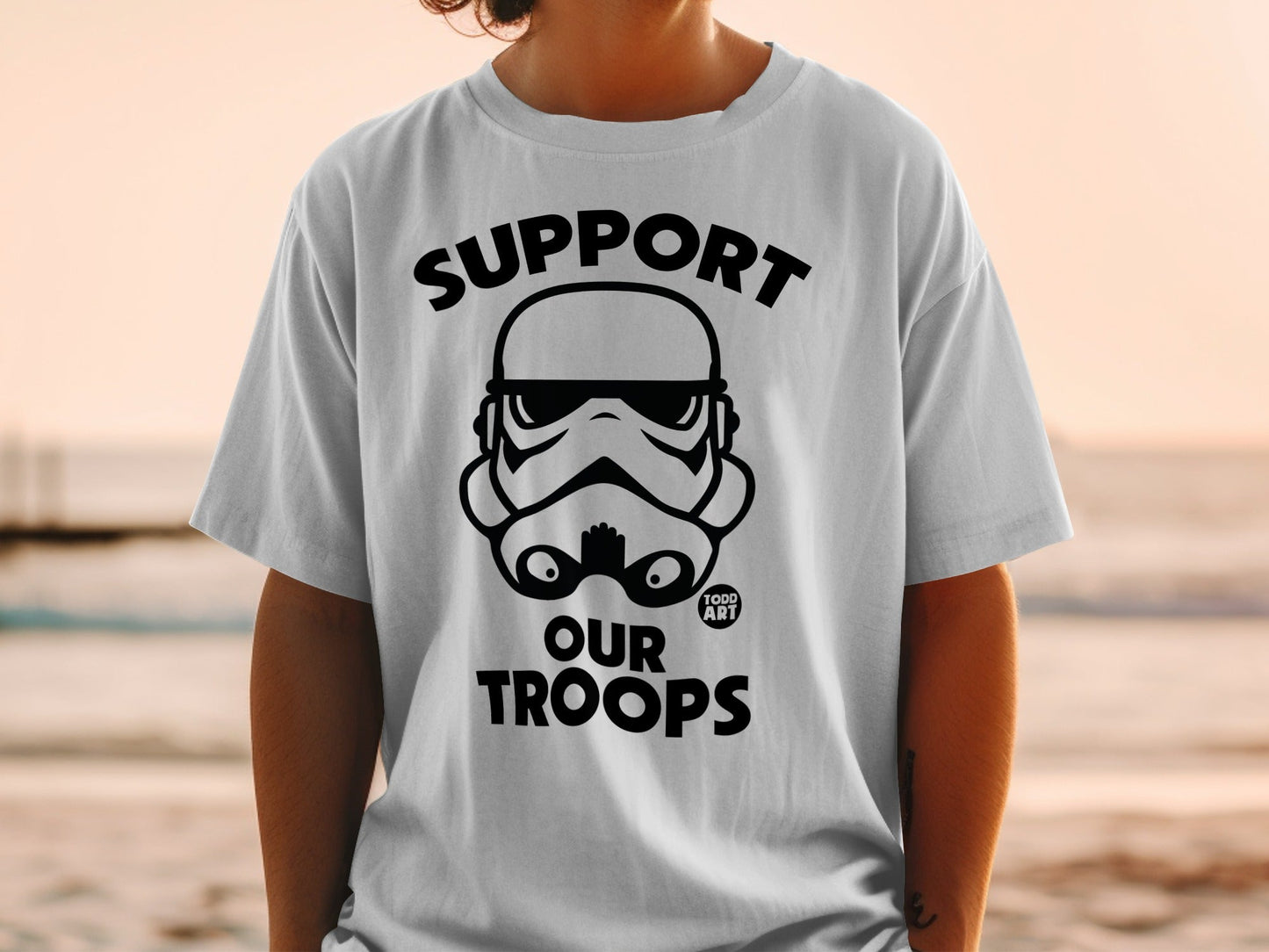 Stormtrooper helmet graphic with "SUPPORT OUR TROOPS" text on a white t-shirt.