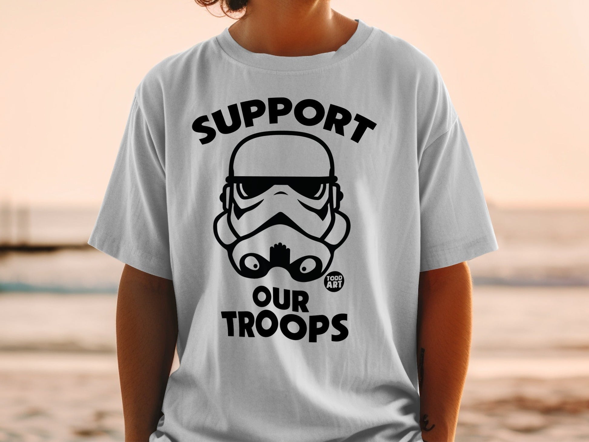 Stormtrooper helmet graphic with "SUPPORT OUR TROOPS" text on a white t-shirt.