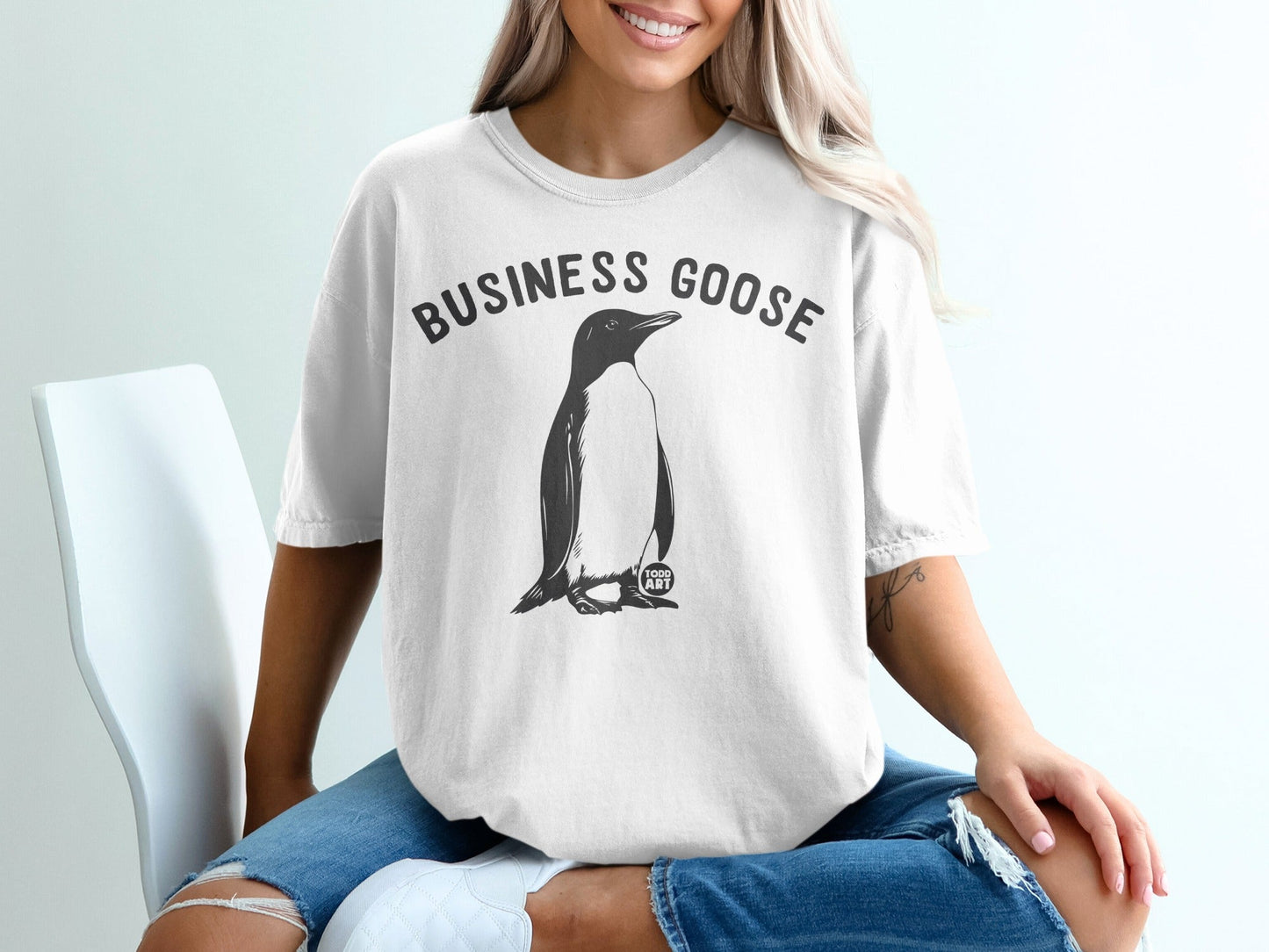 White t-shirt with "Business Goose" text and a penguin graphic.