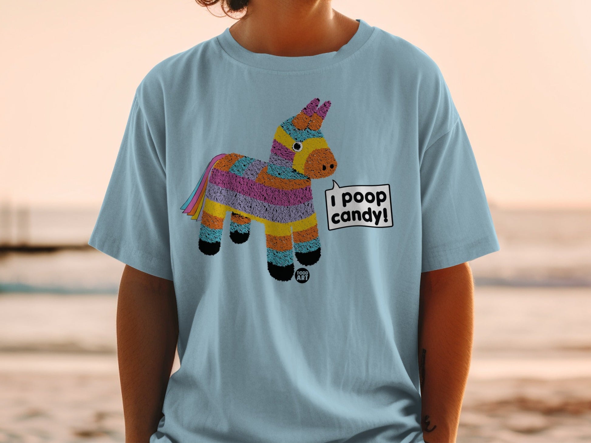 Light blue t-shirt with colorful pinata graphic and "I POOP CANDY!" text.