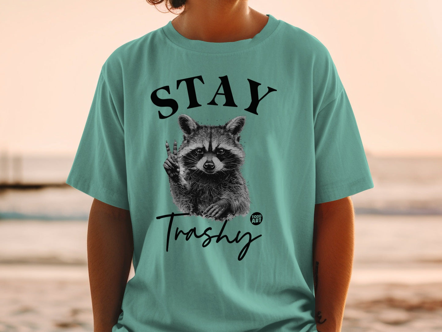 T-shirt with raccoon holding cigarette and text "STAY Trashy"
