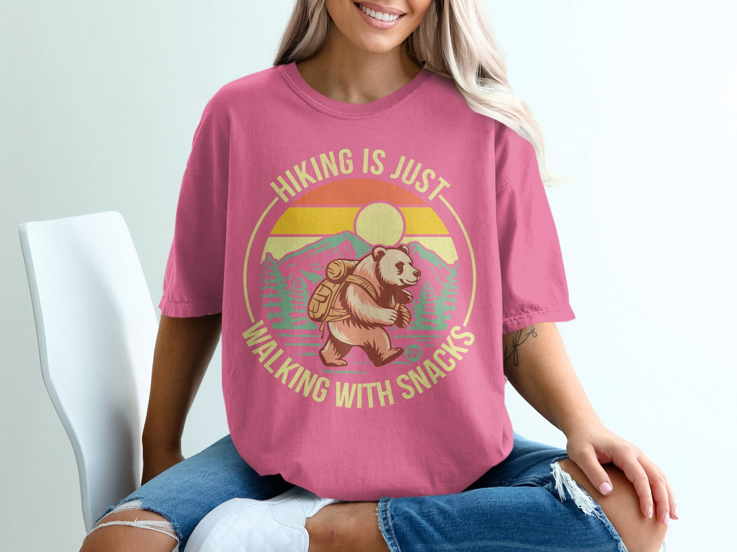 Pink t-shirt with bear hiking graphic and text "Hiking is just walking with snacks".