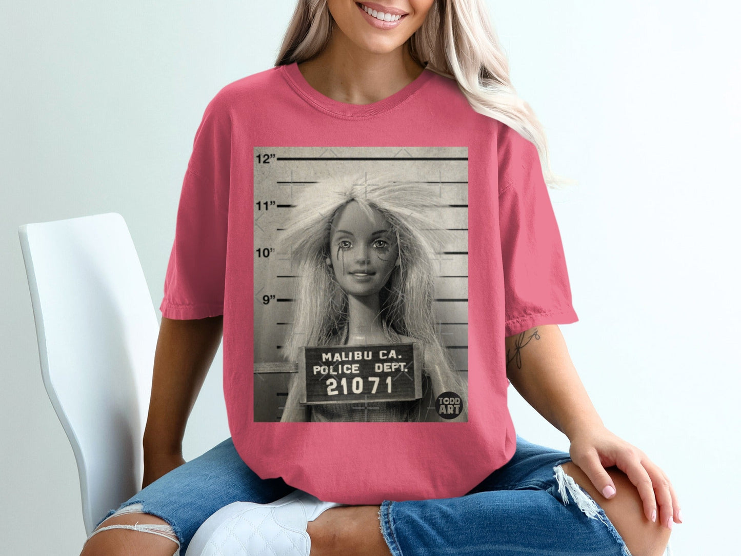 Mugshot of a Barbie doll with "Malibu Ca. Police Dept. 21071" text.