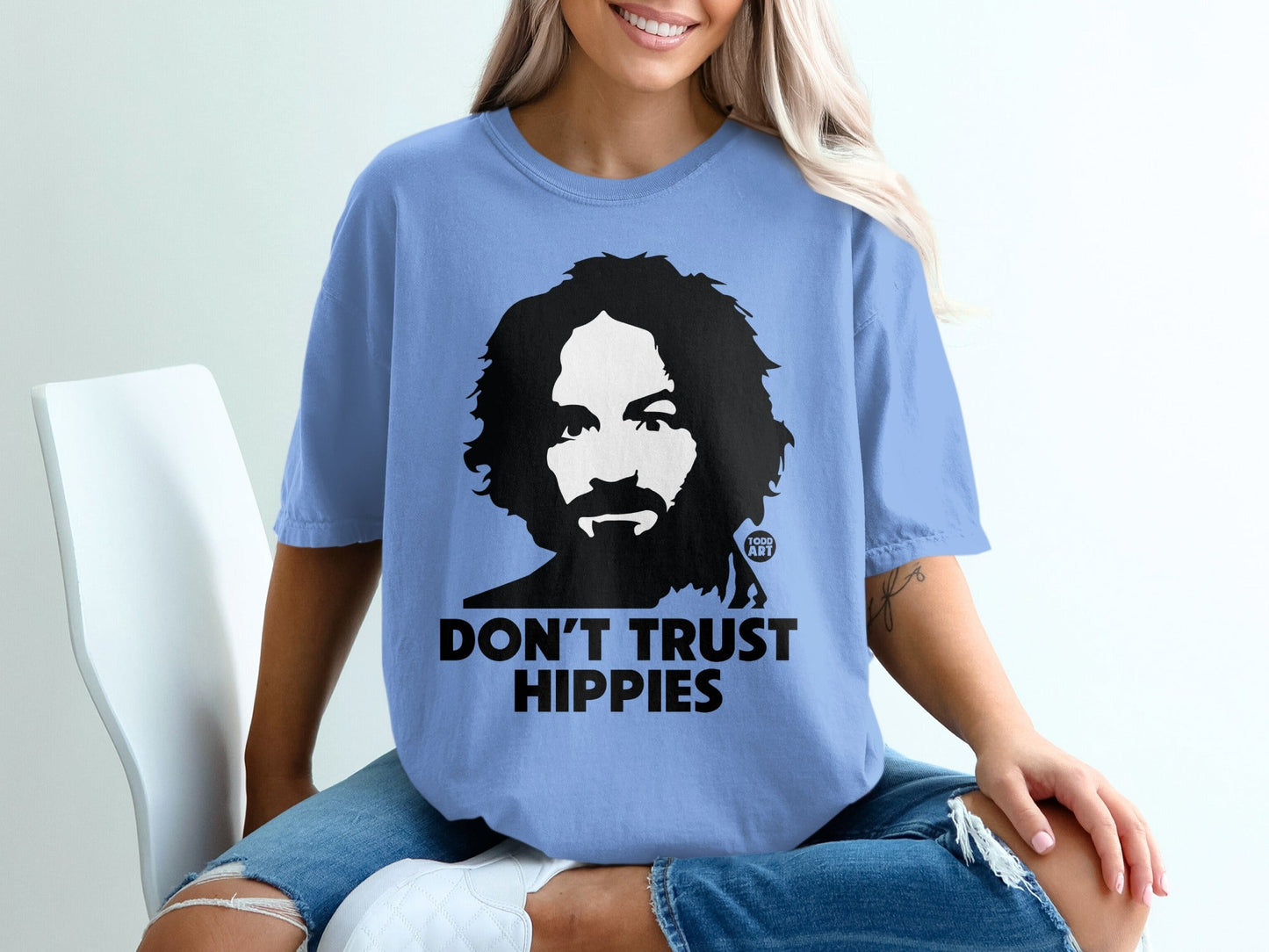 Blue t-shirt with black graphic of a man and "Don't Trust Hippies" text.