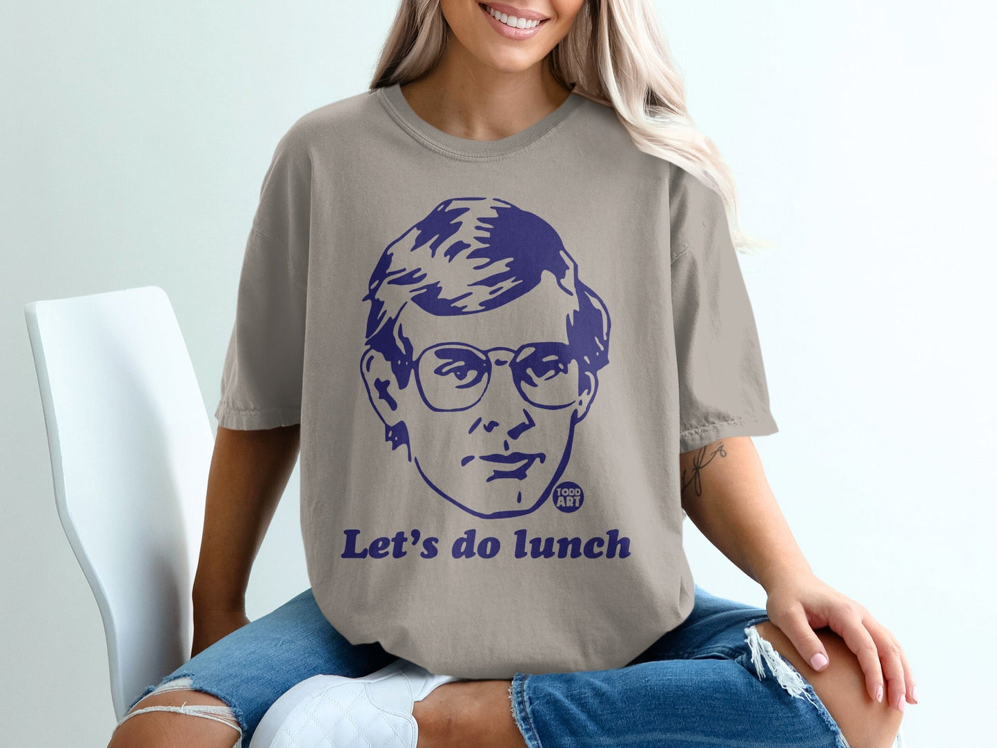 T-shirt with blue graphic of a man's face and "Let's do lunch" text.