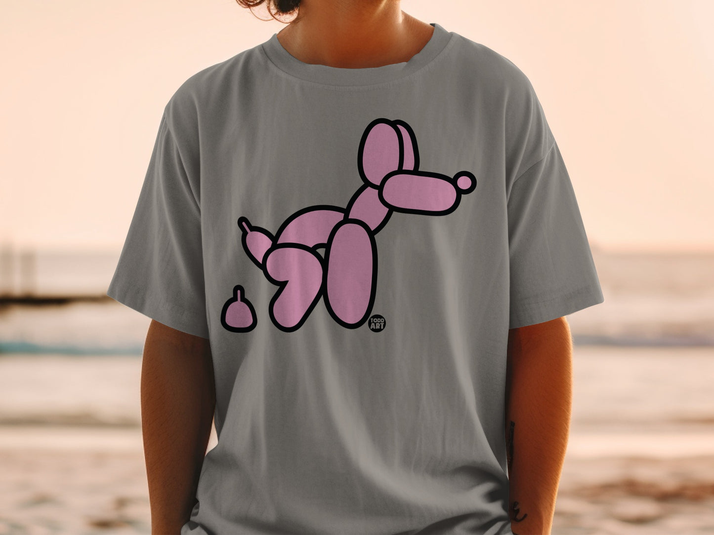 Pink balloon dog with poop graphic on gray t-shirt.