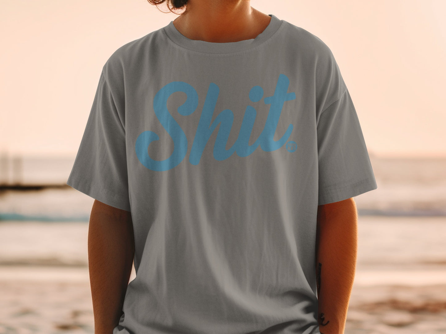 Grey t-shirt with "Shit" in blue script text.