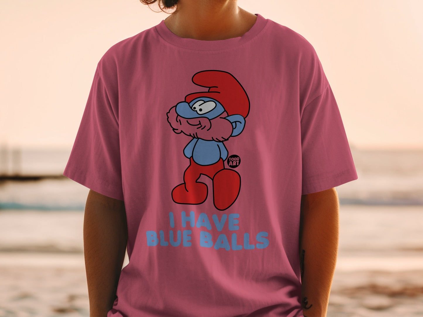 Smurf character on pink t-shirt with "I HAVE BLUE BALLS" text.
