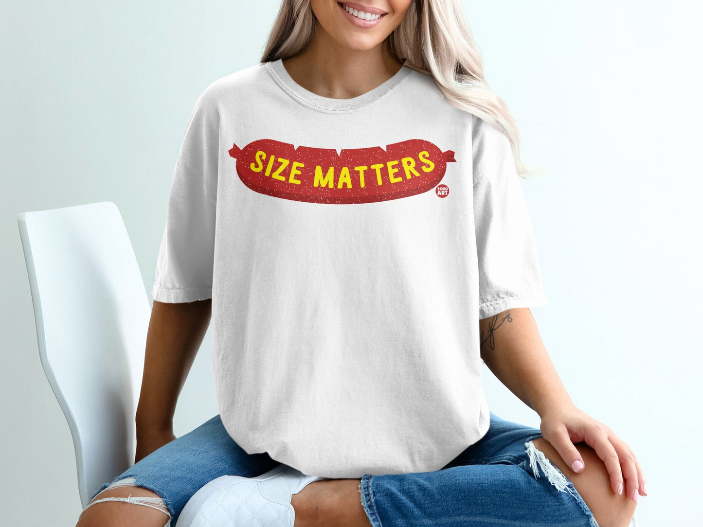White t-shirt with red sausage graphic saying "Size Matters".