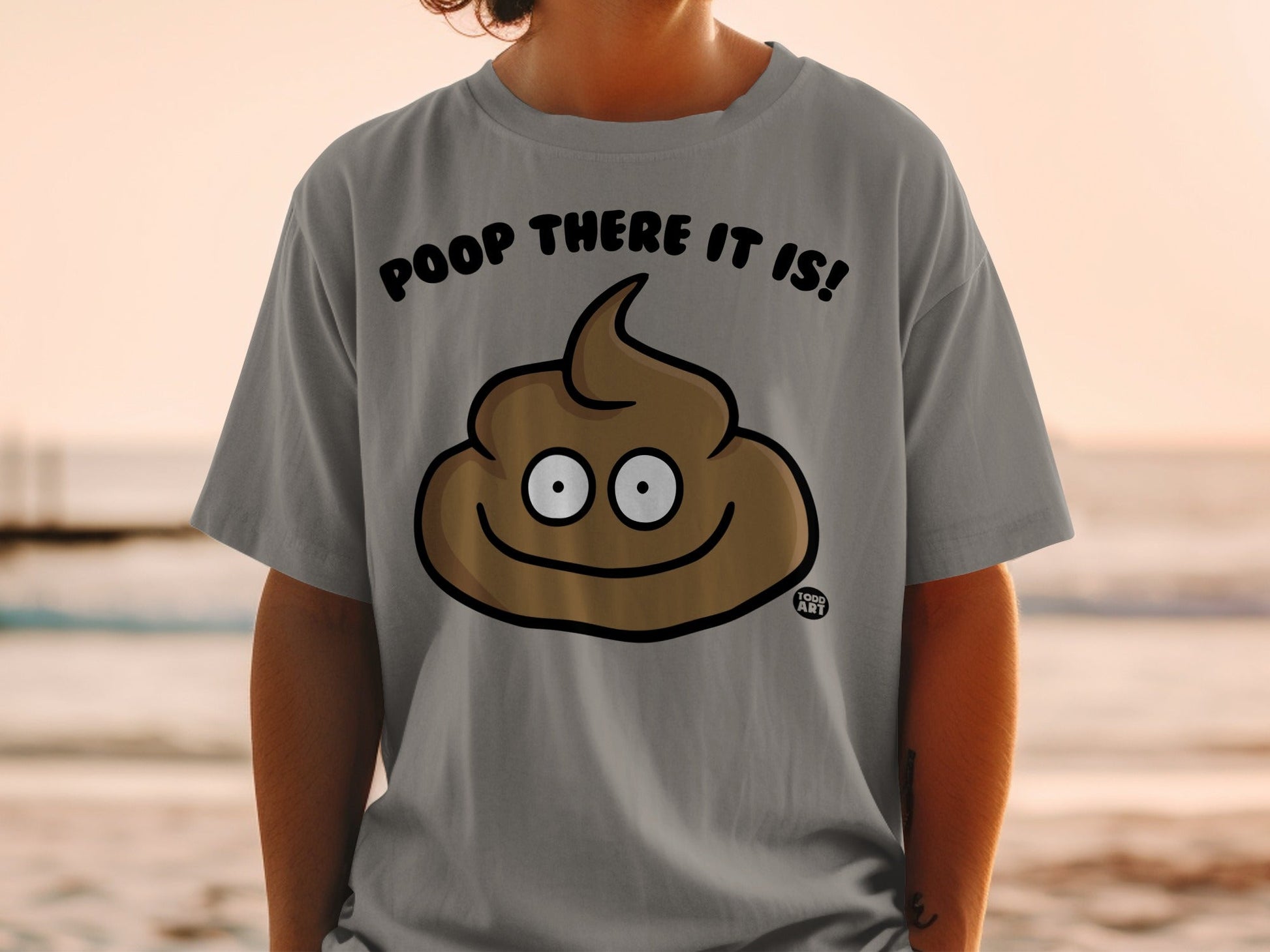 Grey t-shirt with a cartoon poop emoji and the text "POOP THERE IT IS!".