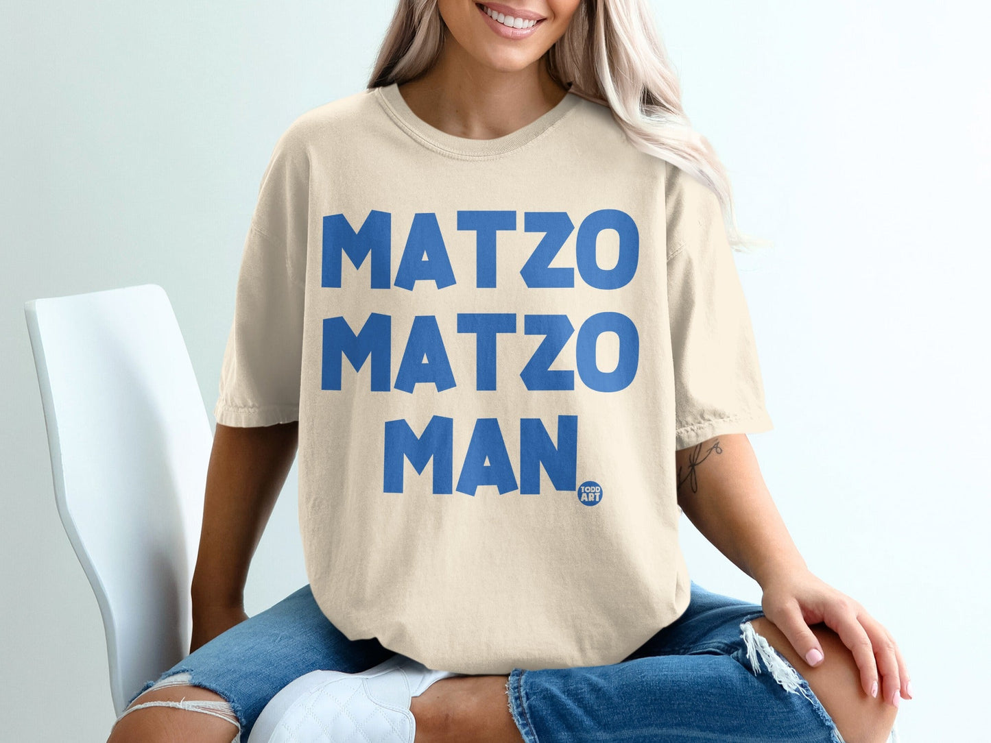 T-shirt with large blue text reading "MATZO MATZO MAN" and a small logo.