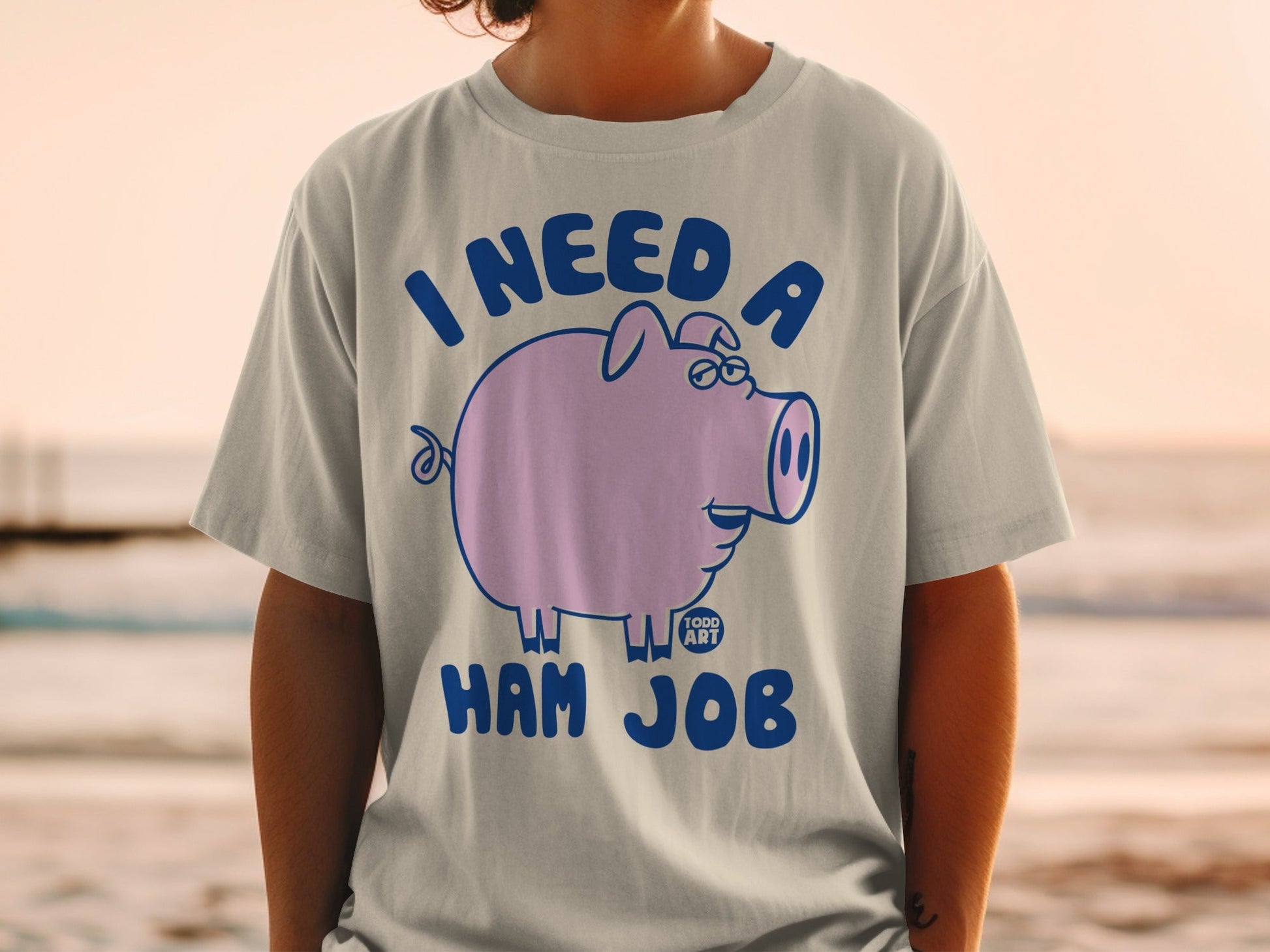 T-shirt with a cartoon pig wearing glasses and text "I NEED A HAM JOB".