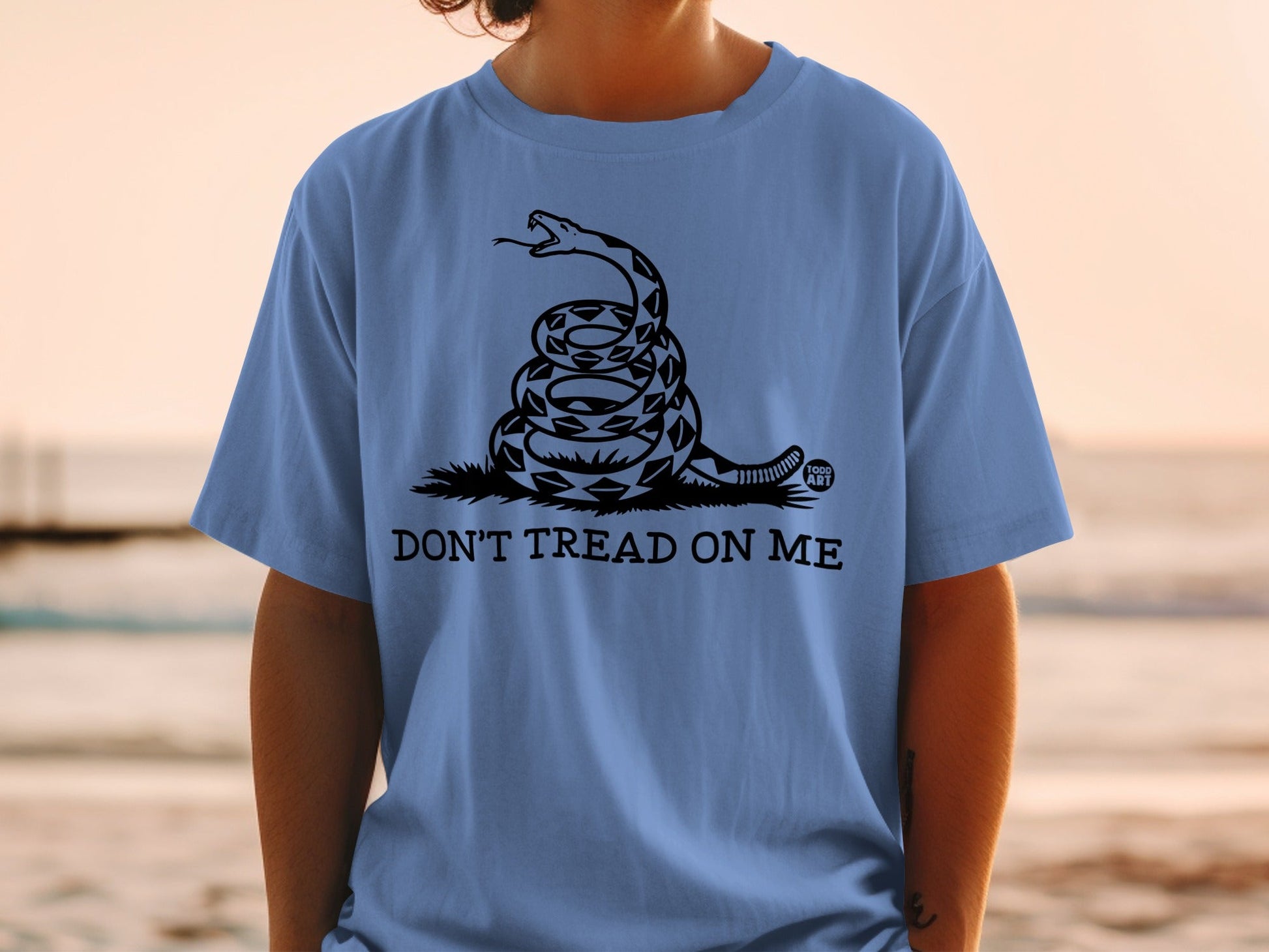 Blue t-shirt with coiled rattlesnake and "DON'T TREAD ON ME" text.
