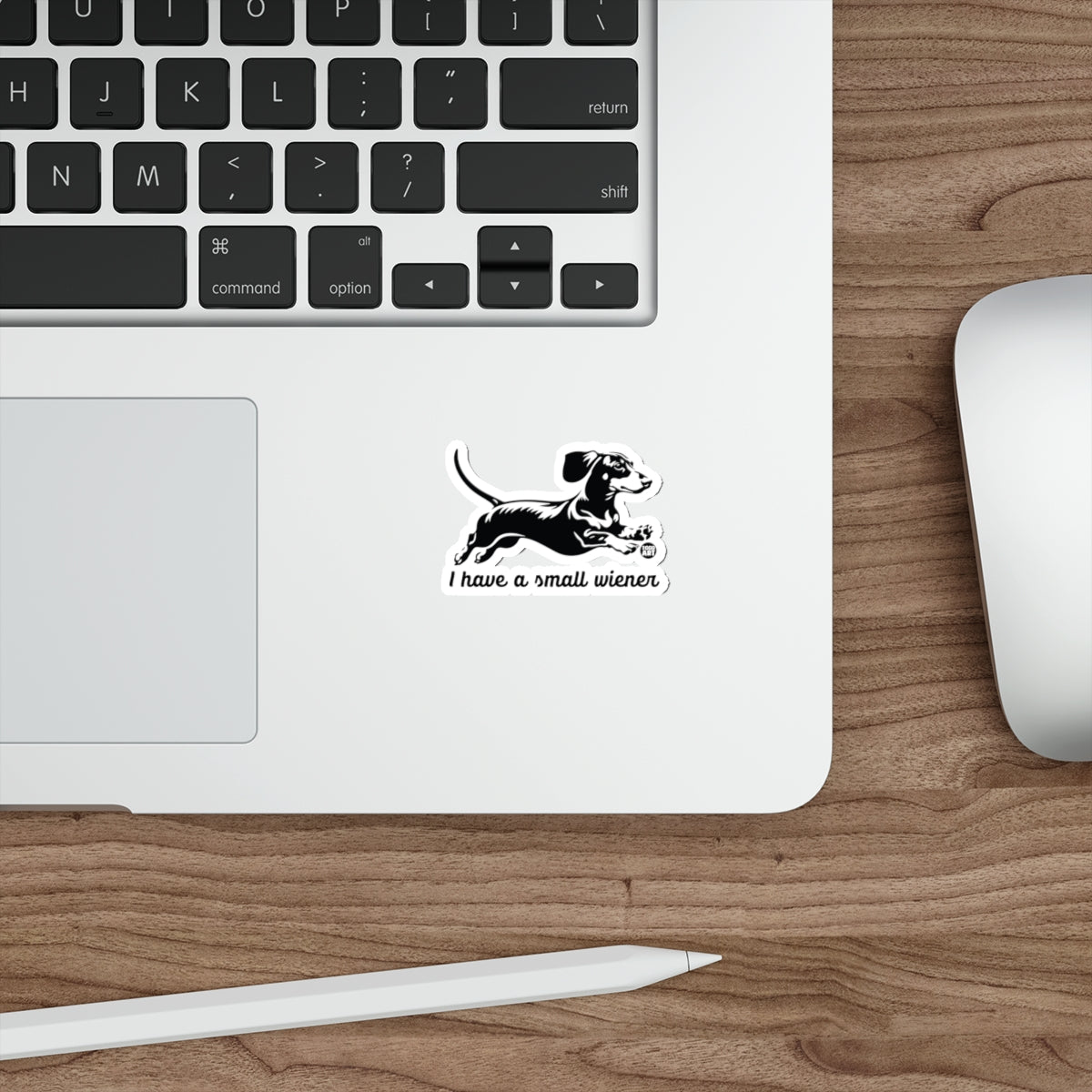 Black and white sticker of a dachshund running with text "I have a small wiener".