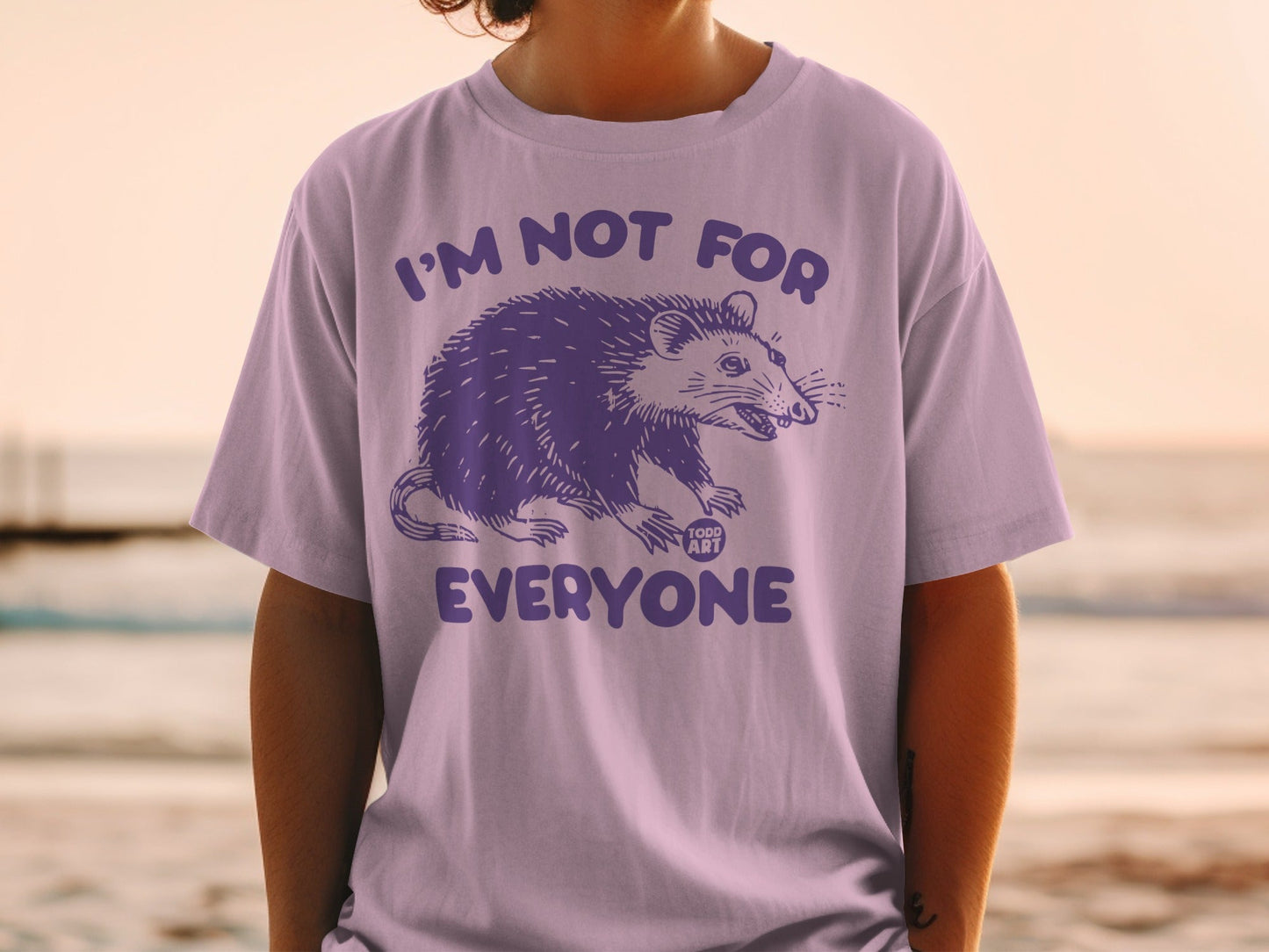 Purple graphic tee with possum and text "I'M NOT FOR EVERYONE".