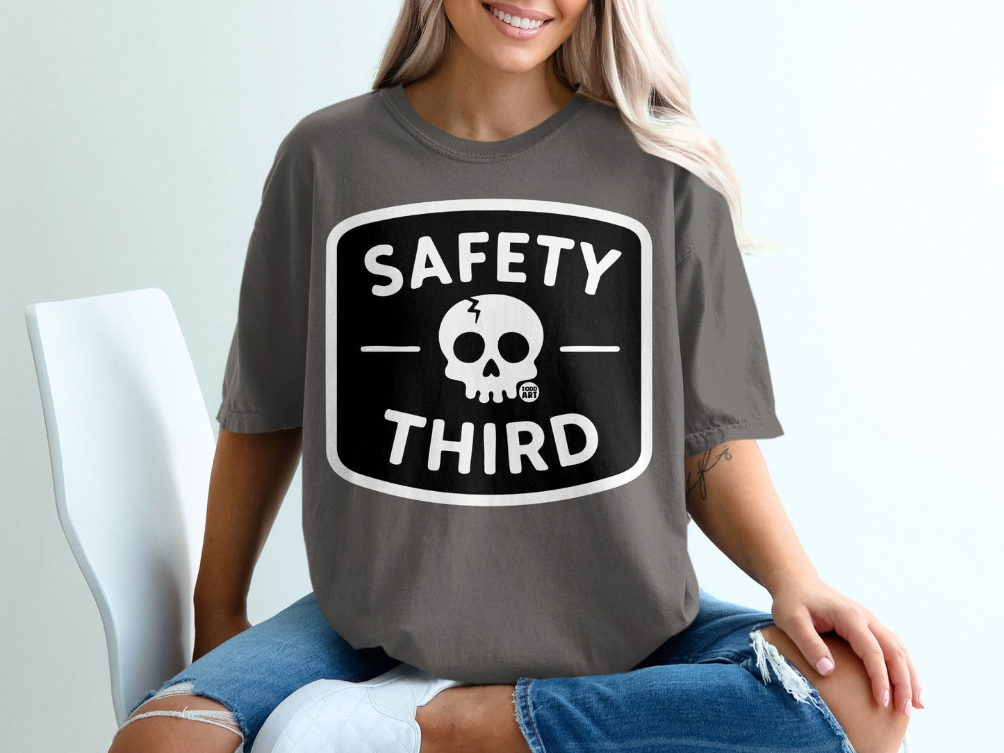 Gray t-shirt with black square logo featuring "SAFETY THIRD" and a skull.