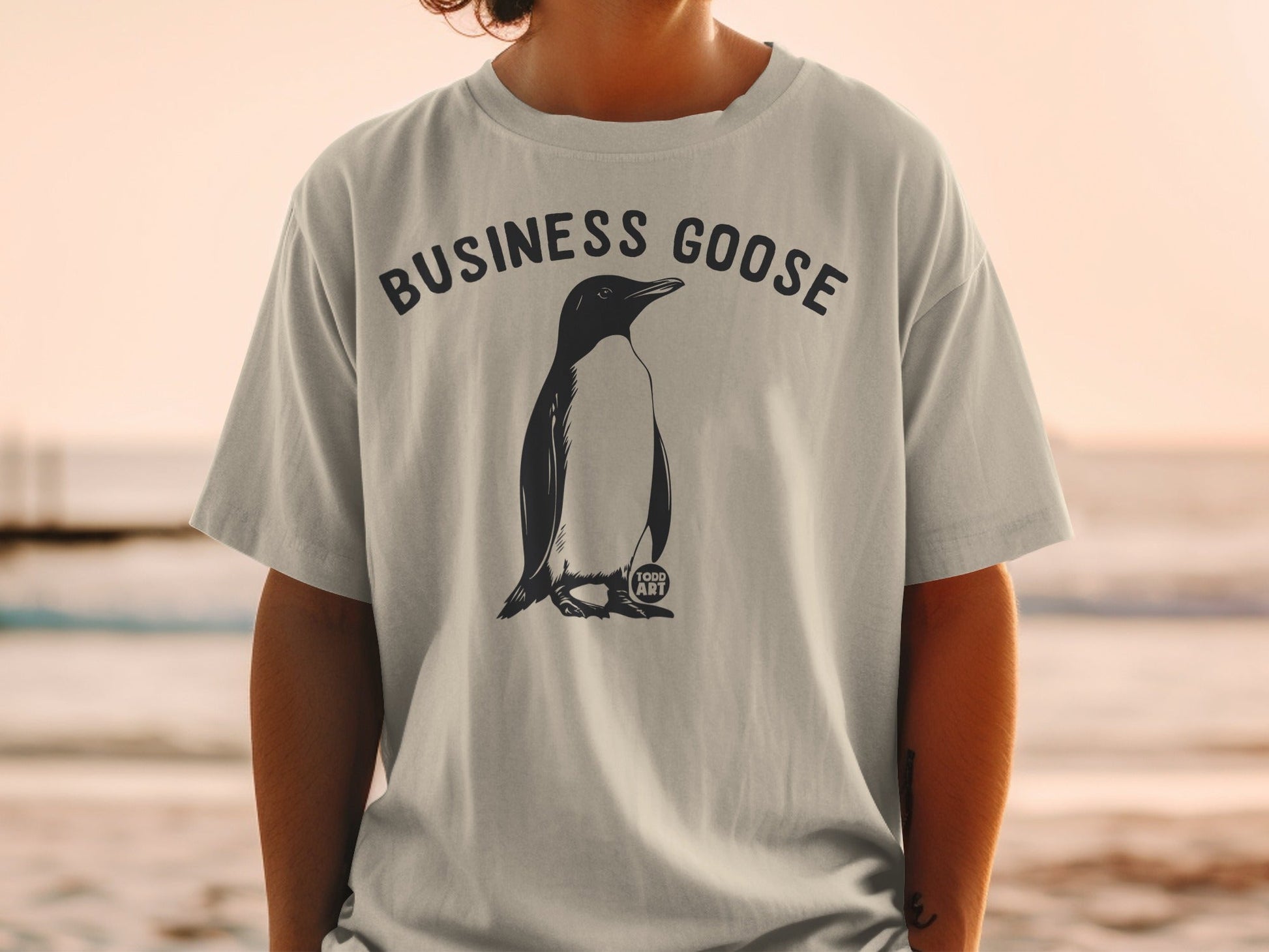 T-shirt with "BUSINESS GOOSE" text and a penguin graphic.