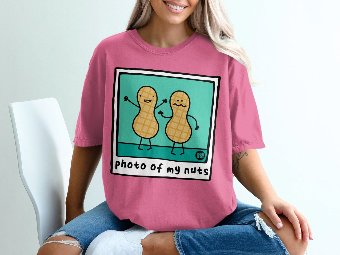 Pink t-shirt with "photo of my nuts" and cartoon peanut characters.