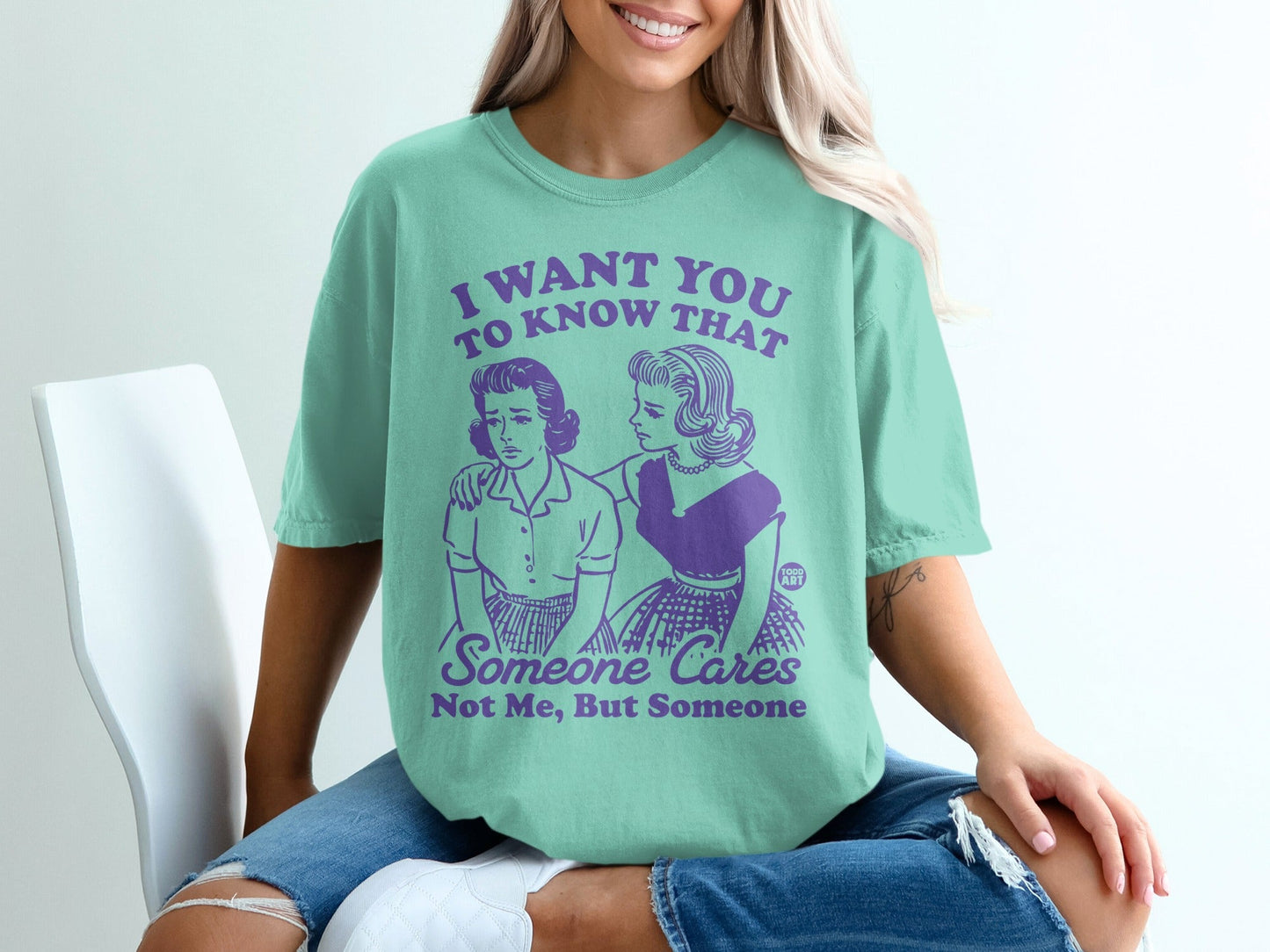 T-shirt with purple text and illustration: "I want you to know that someone cares."