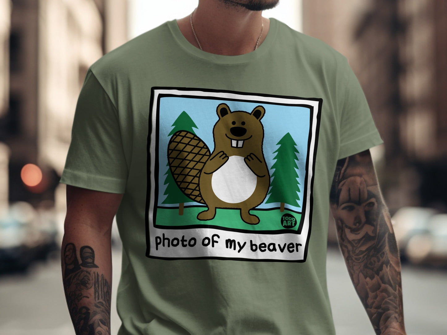 Cartoon beaver and trees on a green t-shirt with "photo of my beaver" text.